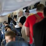 110312-f-nw653-129_passengers_board_a_delta_air_lines_aircraft-590x332.jpg