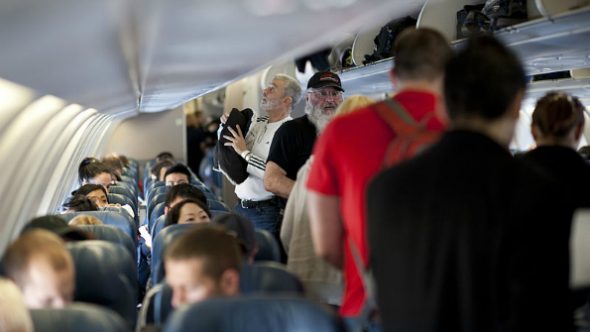 110312-f-nw653-129_passengers_board_a_delta_air_lines_aircraft-590x332.jpg
