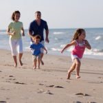 family-running-on-beach-590x392.jpg