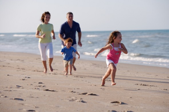 family-running-on-beach-590x392.jpg